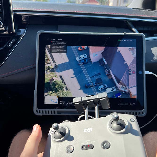 A private investigator operates a drone at high altitude to monitor a person suspected of infidelity.